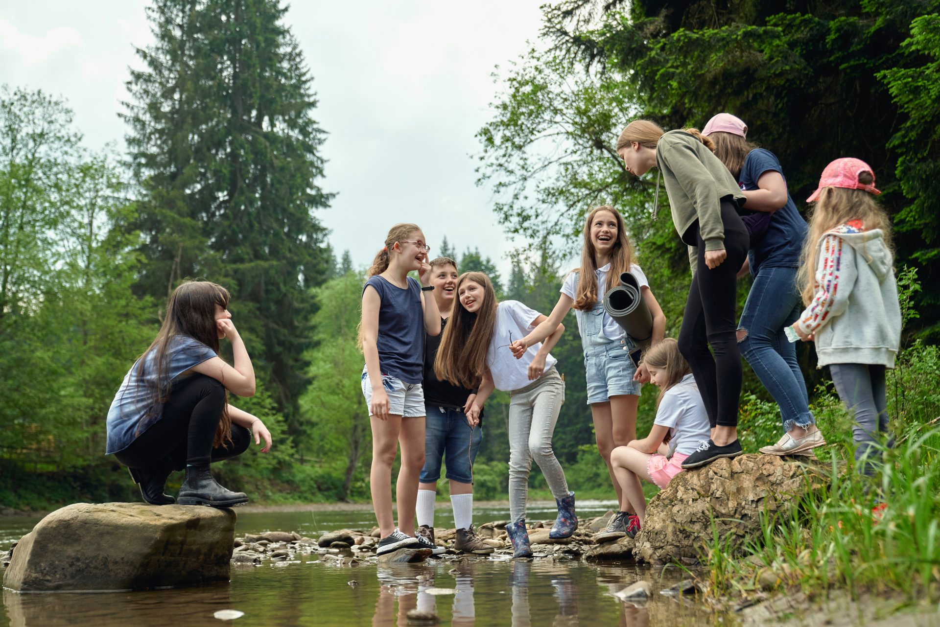Teenage friends having fun on river beach.